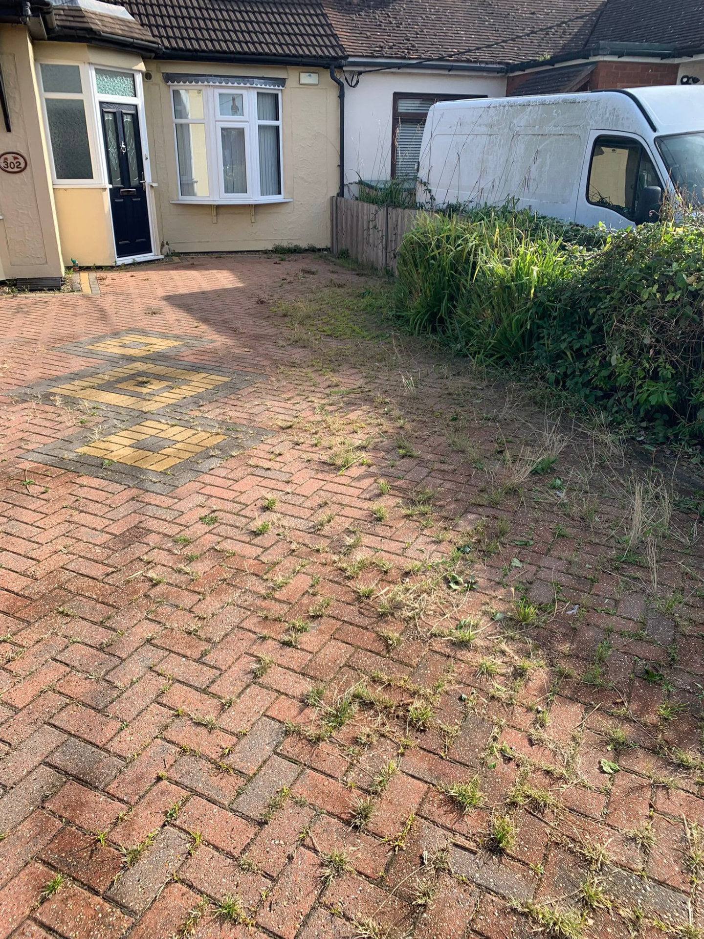 Patterned block-paved driveway before cleaning